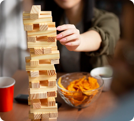 Vrienden spelen Jenga tijdens een gezellige bordspelavond in een café.